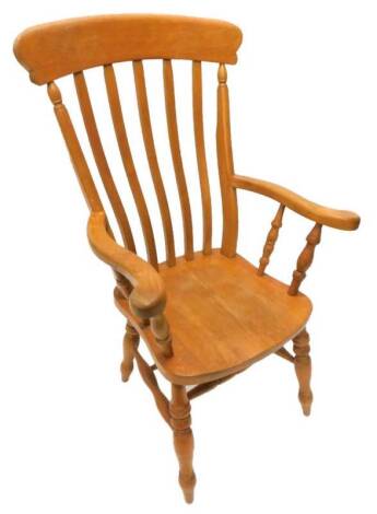 A lathe back kitchen Windsor chair, with a solid seat on turned legs.