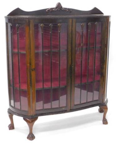 An early to mid 20thC mahogany display cabinet, with a raised back above two glazed doors, enclosing shaped shelves on cabriole legs with ball and claw feet, 118cm W.