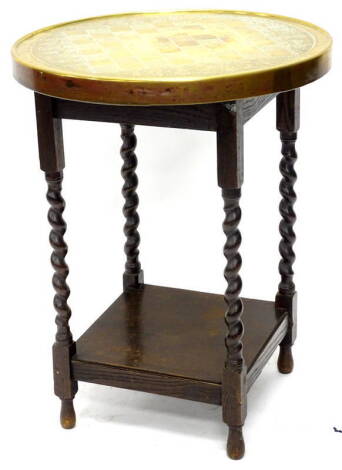 A mid 20th chess table, the circular brass top with hammered decoration and chess pieces etc., on an oak back.