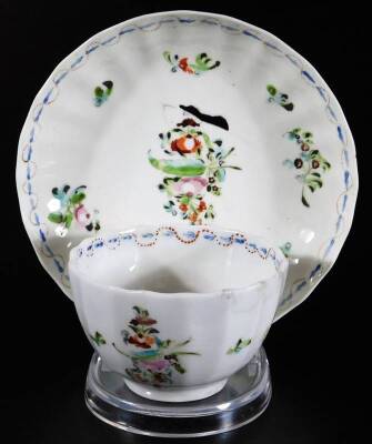 An 18thC Pinxton porcelain tea bowl and saucer, of fluted form, decorated with a copy of the New Hall pattern 126, the tea bowl impressed G, c1796-1799, and an early paste, saucer 14cm Dia., the tea bowl, 8cm Dia. (2) To match the previous lot.