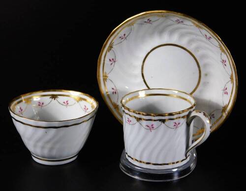 An 18thC Whitehead & Co porcelain trio, comprising coffee can, tea bowl and saucer, each spirally fluted with a pattern of dots, puce, sprigs and gilt lines, unmarked, the saucer 14cm Dia. (3) This may be Mansfield decorated, this pattern also appears on