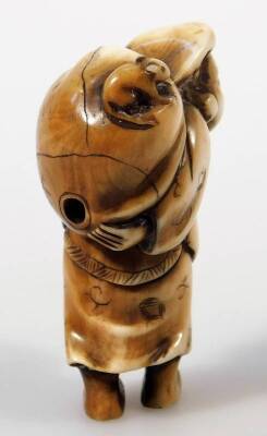 A Japanese Meiji period carved and stained ivory netsuke, formed as a man in standing pose holding sack of his shoulder, marked beneath, 6cm H. - 2