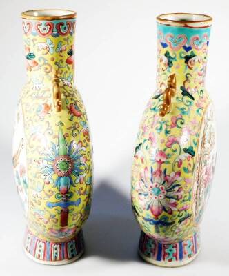 A pair of 19thC Chinese famille jaune porcelain moon flasks, each with compressed cylindrical stems flanked by dragon handles, the circular bodies decorated with panels of birds and figures predominately in yellow, pink, blue, green and orange, on oval fe - 4