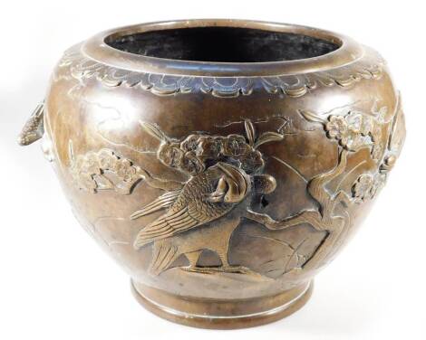 A 19thC Japanese polished bronze jardiniere, of circular tapering form, raised with birds and trees, on a circular foot, partially marked beneath, 23cm H.