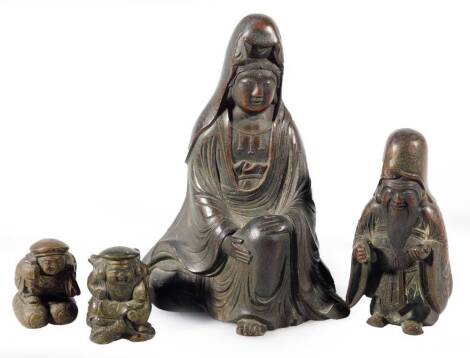 Four Chinese bronze deities, the first being a lady in seated position in flowing robes, 12cm H, script mark beneath, a figure of a sage and two further smaller figures, four and three character marks beneath. (4)