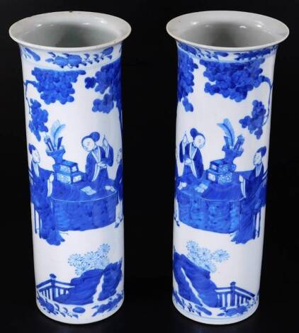 A pair of 19thC Chinese blue and white porcelain vases, each of cylindrical form, decorated with figures of ladies in an exterior setting with prunus and further figures and a lower floral border, double circle marks beneath, 31cm H. (2)