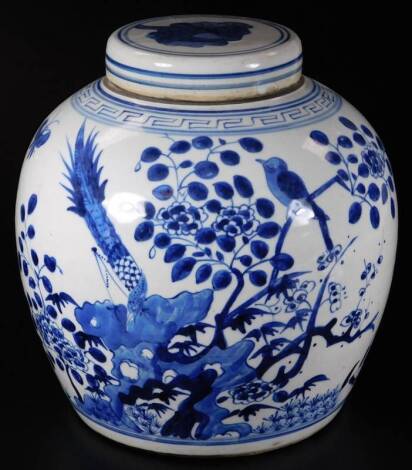 An 18thC Chinese blue and white porcelain ginger jar and cover, the circular body profusely decorated with insects and flowers, 24cm high.