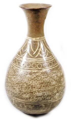 A Korean pottery Buncheong ware vase, stamped with a repeat floral pattern with an upper flower and orb decoration, on circular foot, glazed in cream and brown, 23cm H.