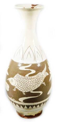 A Korean Koryo pottery vase, with compressed trumpet stem and bulbous body, sgraffito decorated with fish and flowers, in cream and brown glazes, on a circular foot, 34cm H.