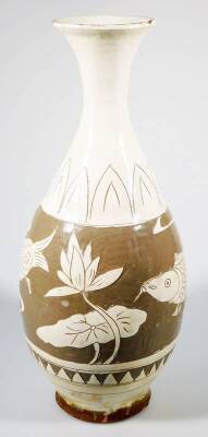 A Korean Koryo pottery vase, with compressed trumpet stem and bulbous body, sgraffito decorated with fish and flowers, in cream and brown glazes, on a circular foot, 34cm H. - 2