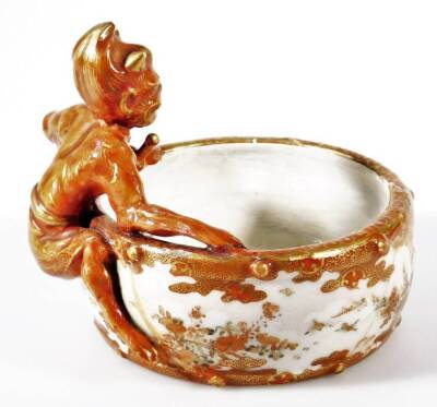 A late 19thC Japanese Meiji period Kutani porcelain bowl, with figure handle decorated with flowers in orange with gilt highlights, nine character mark beneath, 10cm H. - 2