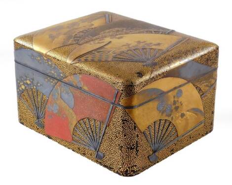 An early 20thC Japanese lacquered box, the oblong body with removable lid, decorated with fans, set with mountains, foliage and a gilt and black ground with a gilt splashed red interior, 15cm H, 27cm W, 20cm D.