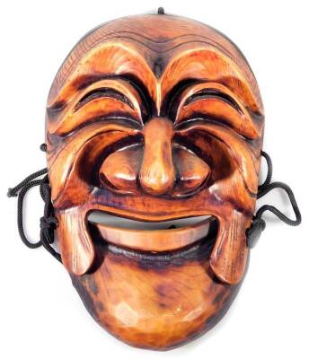 A 20th Korean Hahoe mask, of oval form, with exaggerated features, 30cm H.