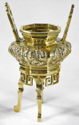 A Chinese polished bronze censer, with raised pierced handles and bombe body, repousée decorated with a repeat floral pattern, with pierced sections beneath, on elongated legs and scroll feet, 27cm H, and two candlestick garniture similar. (3) - 2