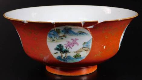 A Chinese Chien Lung porcelain bowl, of flared circular form, decorated with panels of buildings, trees and mountains, on an orange ground with gilt highlights and circular foot, blue seal mark beneath, 20cm Dia. (AF)