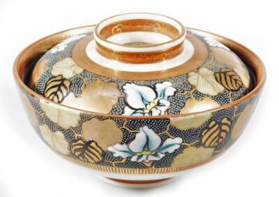 A 20thC Japanese satsuma bowl and cover, of circular form, decorated with a repeat pattern of leaves and flowerheads, with gilt highlights, three character mark beneath, 11cm Dia.