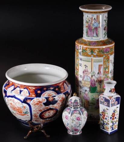 An early 20thC Japanese Imari pattern pottery jardiniere, of compressed circular form, decorated with repeat patterns of flowers with an upper geometric pattern, predominately in orange and blue, 25cm Dia., and three later vases. (4)