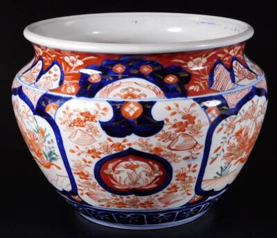 An early 20thC Japanese Imari pattern pottery jardiniere, of compressed circular form, decorated with repeat patterns of flowers with an upper geometric pattern, predominately in orange and blue, 25cm Dia., and three later vases. (4) - 7