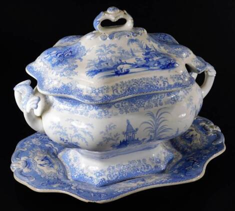 A 19thC Chinese blue and white pottery tureen, printed with oriental inspired landscape, with a cover and stand, c1860, marked CHIANG NAN CHINA, 28cm H.