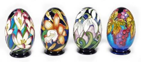 Four Moorcroft pottery Changing Season eggs, 11cm H. (boxed)