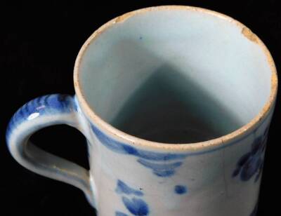 An 18thC Chinese blue and white export porcelain coffee can, the cylindrical body with decorative handle on a circular foot, Kangxi floral mark beneath, 6cm H. (AF) - 3