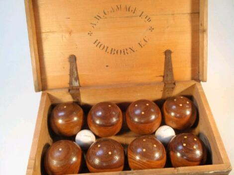 Two sets of four numbered lignum vitae bowls with porcelain jacks