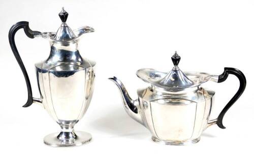 A George V silver two piece service, comprising of a coffee pot, 28cm H and teapot, each with an ebonised knop and angular handle, on oval feet, Sheffield 1917 and 1918, 31oz all in. (2)