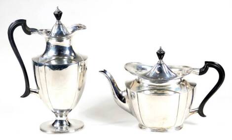 A George V silver two piece service, comprising of a coffee pot, 28cm H and teapot, each with an ebonised knop and angular handle, on oval feet, Sheffield 1917 and 1918, 31oz all in. (2)