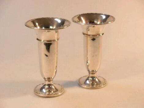 A pair of early George V silver trumpet vases