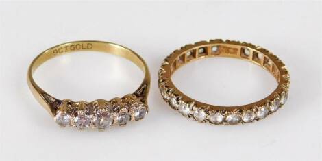 Two dress rings, comprising a 9ct gold five stone dress ring, set with five imitation diamonds, ring size R, and an eternity ring set with imitation diamonds, marked 9ct and sil, ring size P½, 3.9g all in.