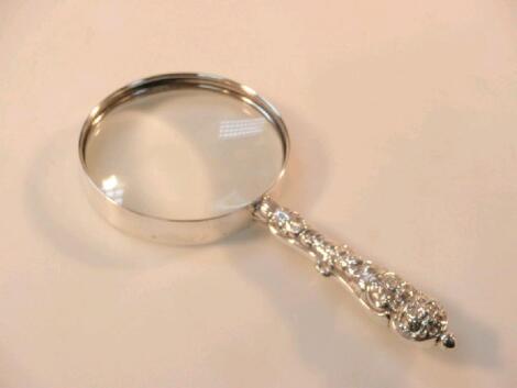 A late Victorian silver magnifying glass with an embossed handle
