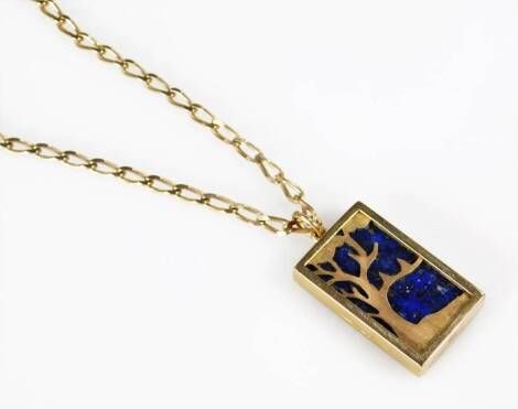 A 9ct gold pendant and chain, 9ct gold lapis lazuli backed rectangular pendant, with engraved design of a tree, on a later fancy link chain, stamped 9ct, the pendant 2.5cm H, 16.7g all in.