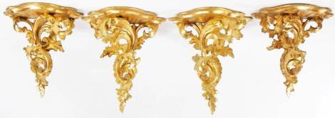 A set of four two sized rococo style gilt wood wall sconces, with a scroll and floral stem, 27cm H. (4)