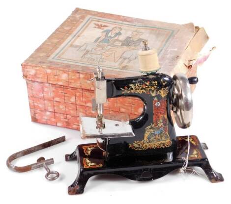 An early 20thC tin plate child's improved sewing machine, stencilled with articulated chrome plated handle, 21cm H. (boxed)