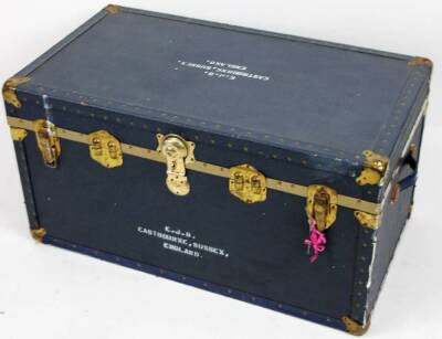 A 20thC steamer trunk, in blue pressed leather, of rectangular form, partially studded with side handles and heavy metal locks, with some labels and a fitted interior with removable sections, marked EJB EASTBOURNE SUSSEX ENGLAND, 48cm H, 91cm W, 55cm D.