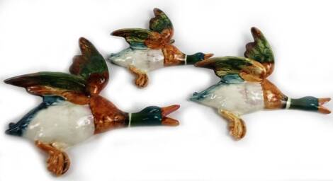 A set of three Beswick graduated duck wall plaques, 24cm W, etc., no. 596-2, 3, and 4, impressed marks verso. (3)