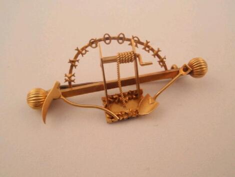 An Australian goldminer brooch with attached pick