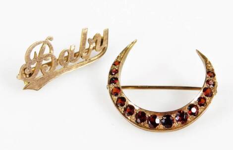 Two brooches, comprising a 9ct gold baby brooch and a 9ct gold crescent brooch, set with garnet, 3.5g all in. (2)