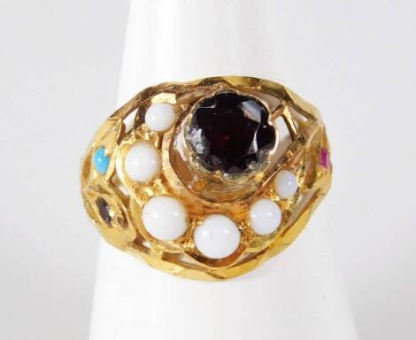 An elaborate dress ring, set with garnet, turquoise and white stones, gold plated ring design, ring size N. From the estate of R J 'Bob' Curry (Dec'd) of Grantham.