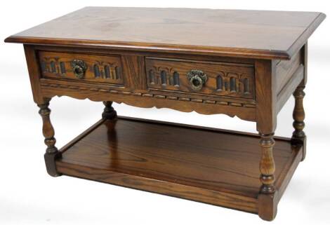 A 20thC Old Charm style coffee table, the plain top raised above four frieze drawers, on turned legs.