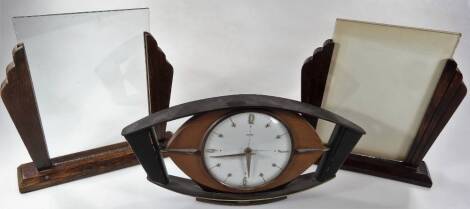 A 1950's Metamec mantel clock, with 11cm Dia. Arabic and dot pointers, in a teak case, and two oak Art Deco frames. (3)