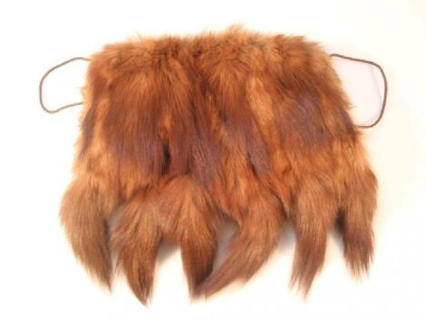 A fox fur muff with neck cord