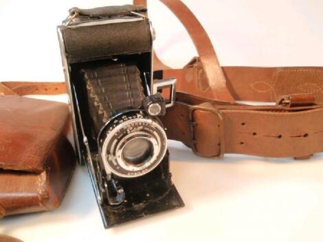 A Sam Brown leather belt and an Ensign folding camera