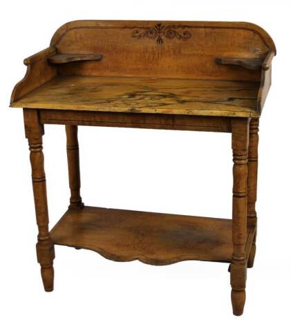 A 19thC painted pine wash stand, with three part galleried over run top, on turned legs joined by a shaped undertier, 99cm H, 98cm W, 48cm D.