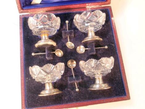 A set of four Edward VII silver and cut glass salts