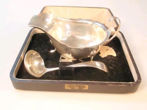 A George V silver sauce boat and ladle by Viners