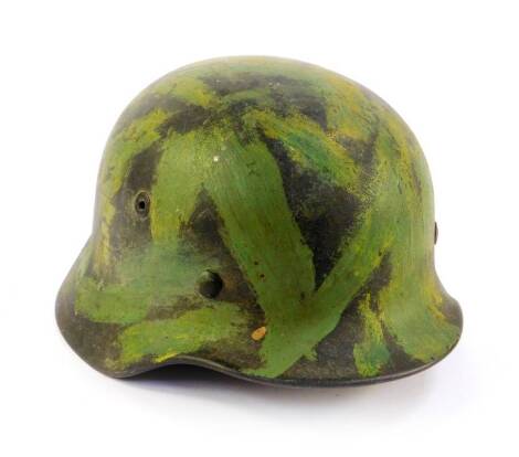 A German Third Reich army camouflage helmet, M35, stamped number 355 and 390.