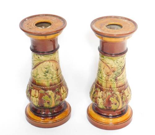 A pair of Doulton Lambeth late 19thC stoneware jardiniere stands, of baluster form, tube line decorated with scrolling leaves, impressed marks, 50cm H.