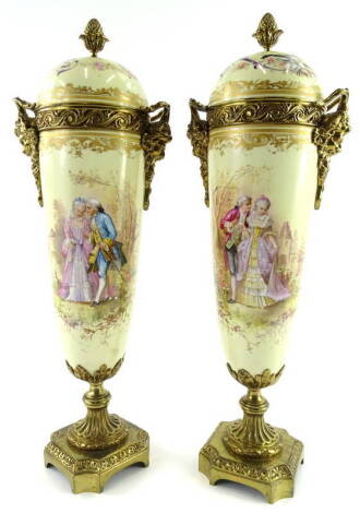 A pair of Sevres style porcelain urns and covers, each with gilt metal mounts and decorated with French style scenes, signed Philippot, on a square base, 46cm H.