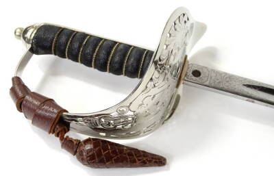 A George V dress sword, with an engraved blade, shark skin handle and pierced guard, housed within a brown leather scabbard with outer travelling case, sold with an accompanying plated scabbard, 101cm L.